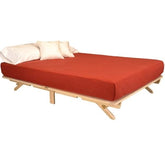 A cozy bed adorned with a bright red cover, inviting and well-arranged.